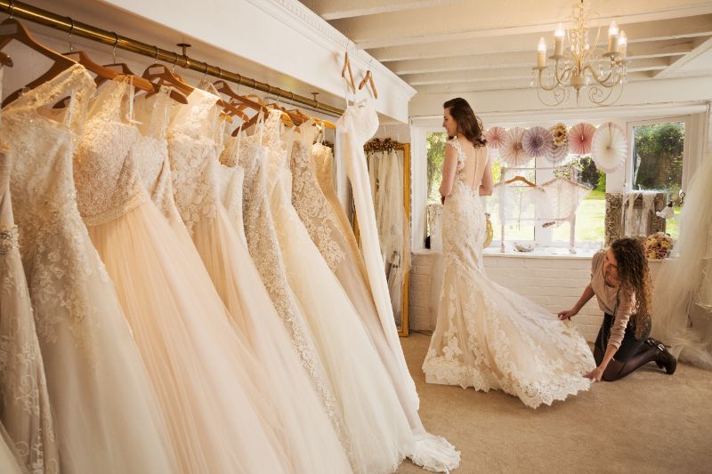 Rows of wedding dresses on display in a wedding dress shop
