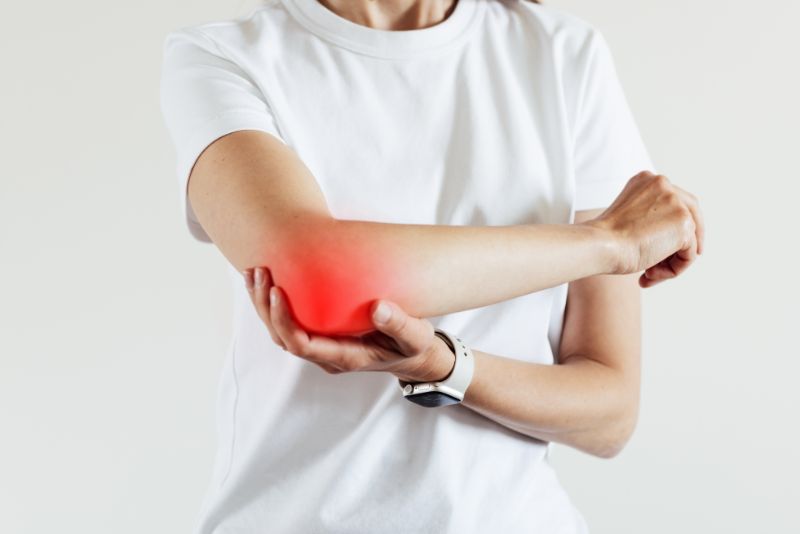 A woman wearing white shirt suffering from joint pain